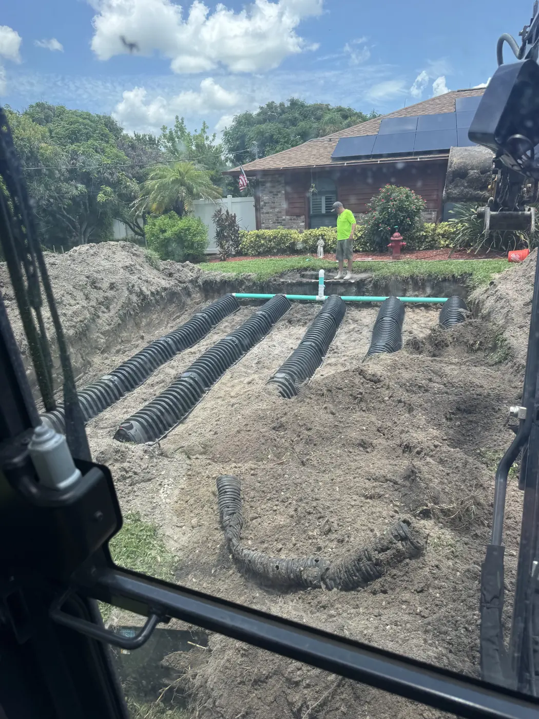 Drain field rows seen from the excavator cab