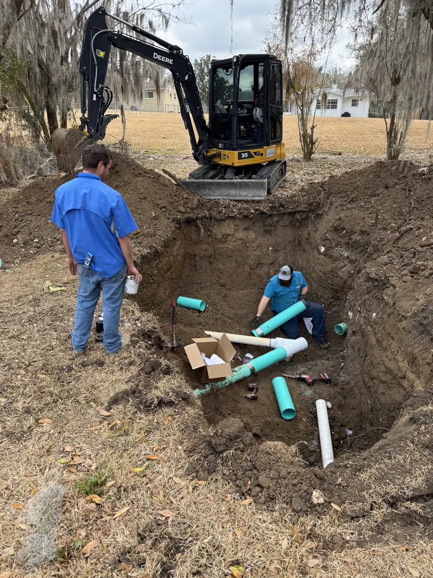 Crew connecting new lines at a septic tank
